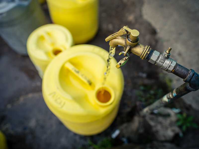 Image of water flowing into a yellow tap.