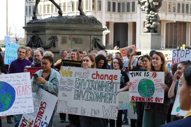 A crowd of protesters with placards advocating for different causes.